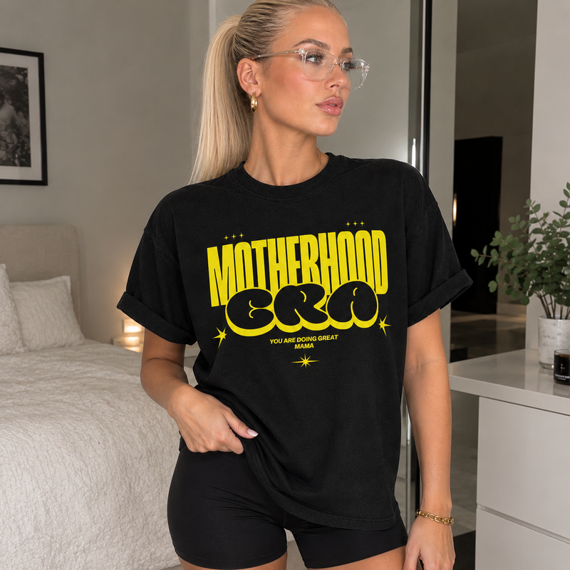 Motherhood Era black t-shirt with retro lettering and the message You Are Doing Great Mama